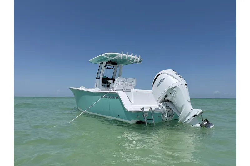 Slide: The Image of 2024 Sportsman Open 232 Center Console boat in calm ocean waters, featuring Yamaha outboard motor. - 2