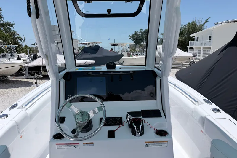 Slide: The Image of 2024 Sportsman Open 232 Center Console boat interior with steering wheel and control panel. - 5