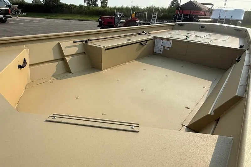 Slide: The Image of 2026 Crestliner 1860 Retriever Deluxe boat interior, showcasing spacious deck and storage compartments. - 5