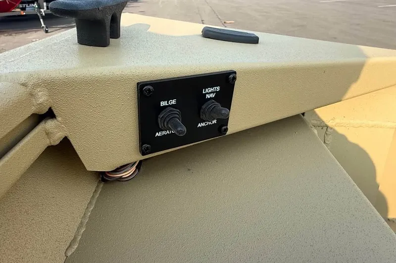Slide: The Image of Control panel on 2026 Crestliner 1860 Retriever Deluxe boat with bilge and light switches. - 11