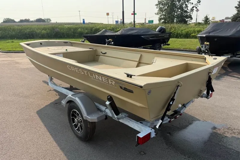 Slide: The Image of 2026 Crestliner 1860 Retriever Deluxe boat on trailer, parked outdoors. - 3