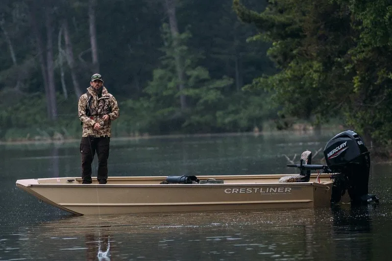 Slide: The Image of Manufacturer Provided Image: Man fishing on 2026 Crestliner 1860 Retriever Deluxe boat in serene lake setting. - 16