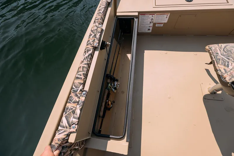Slide: The Image of Manufacturer Provided Image: 2026 Crestliner 1860 Retriever Deluxe boat with open storage compartment and camo seating. - 18