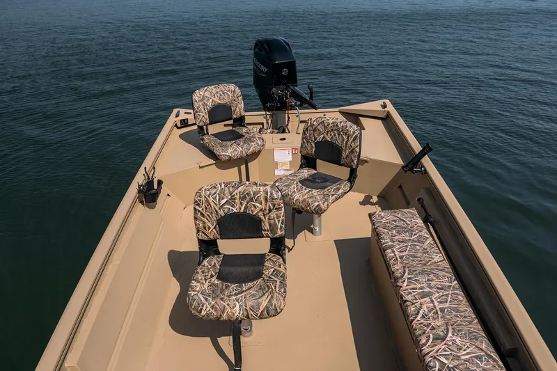 Slide: The Image of Manufacturer Provided Image: 2026 Crestliner 1860 Retriever Deluxe boat with camo seats on calm water. - 19