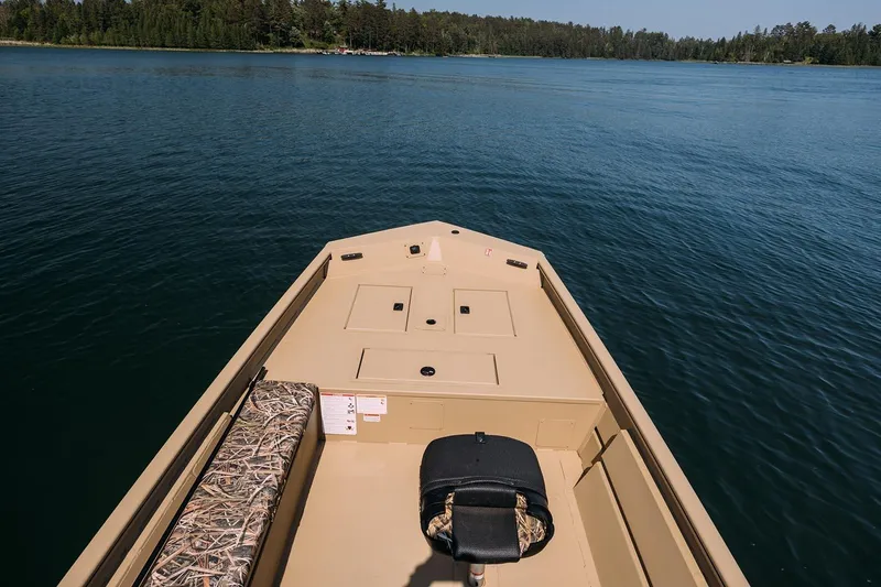 Slide: The Image of Manufacturer Provided Image: 2026 Crestliner 1860 Retriever Deluxe boat on serene lake with forested shoreline. - 17