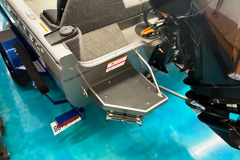Slide: The Image of 2023 Crestliner 1650 Fish Hawk boat with motor and trailer on blue floor. - 6
