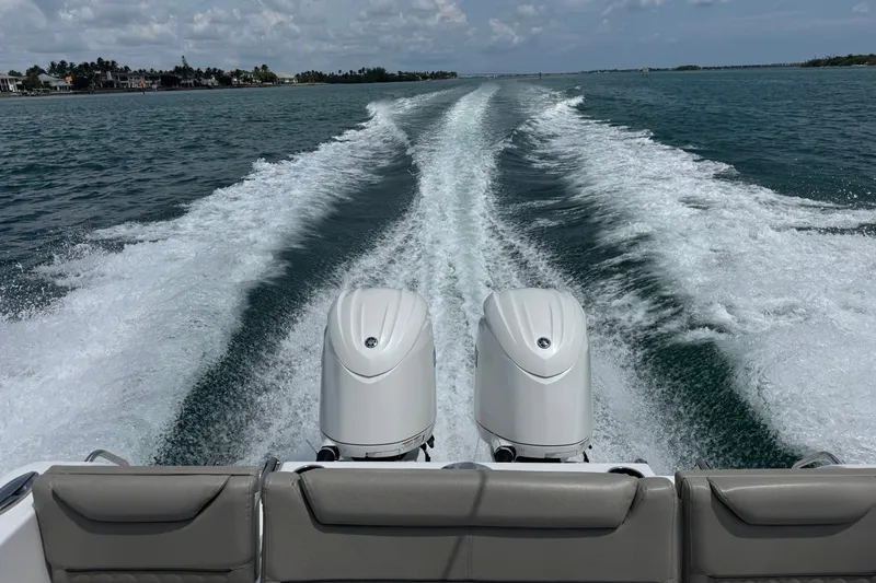 Slide: The Image of 2024 Sportsman Heritage 261 Center Console cruising on open water, leaving a wake trail. - 13