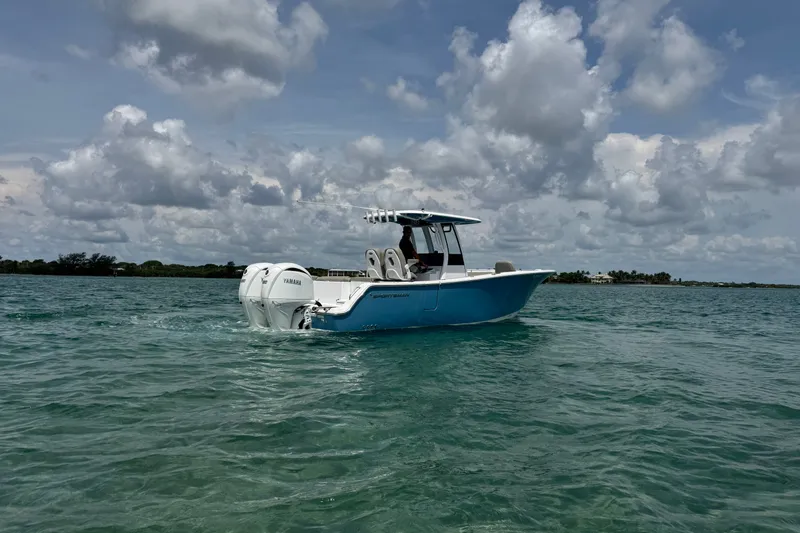 Slide: The Image of 2024 Sportsman Heritage 261 Center Console boat on open water under cloudy sky. - 11