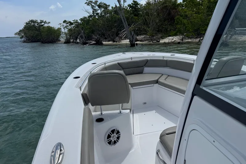 Slide: The Image of 2024 Sportsman Heritage 261 Center Console boat near a scenic shoreline. - 4
