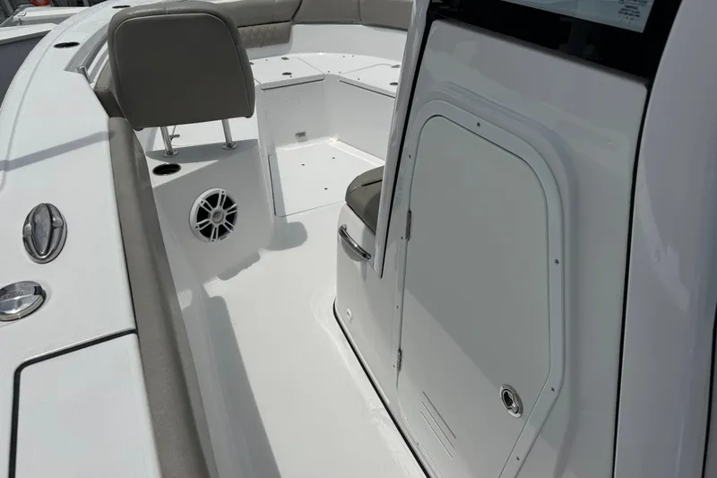Slide: The Image of 2024 Sportsman Heritage 261 Center Console boat interior with seating and speaker. - 18