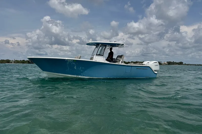 Slide: The Image of 2024 Sportsman Heritage 261 Center Console boat on open water under cloudy sky. - 12