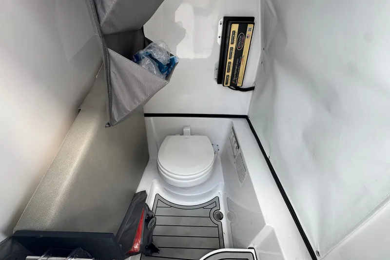 Slide: The Image of 2024 Sportsman Heritage 261 Center Console interior with compact marine toilet. - 21
