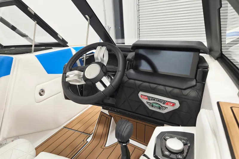 Slide: The Image of 2027 Nautique Super Air Nautique GS20 cockpit with modern steering and control panel. - 4