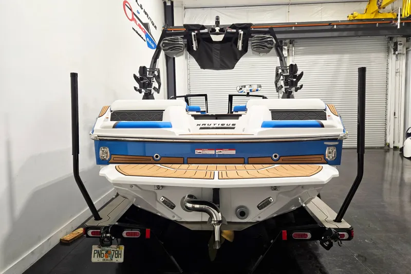 Slide: The Image of 2027 Nautique Super Air Nautique GS20 boat on trailer in garage setting. - 6