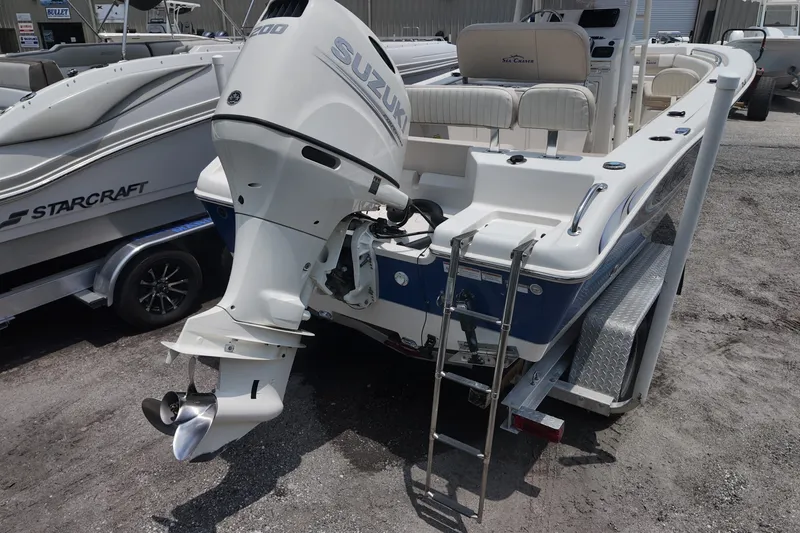Slide: The Image of 2018 Sea Chaser 22 HFC boat with Suzuki outboard motor, parked on a trailer. - 3