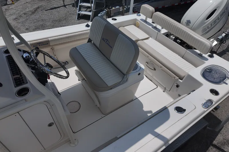 Slide: The Image of 2018 Sea Chaser 22 HFC boat interior with seating and steering wheel, showcasing spacious design. - 9