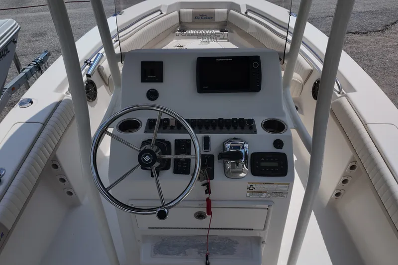 Slide: The Image of 2018 Sea Chaser 22 HFC boat console with steering wheel and controls. - 14