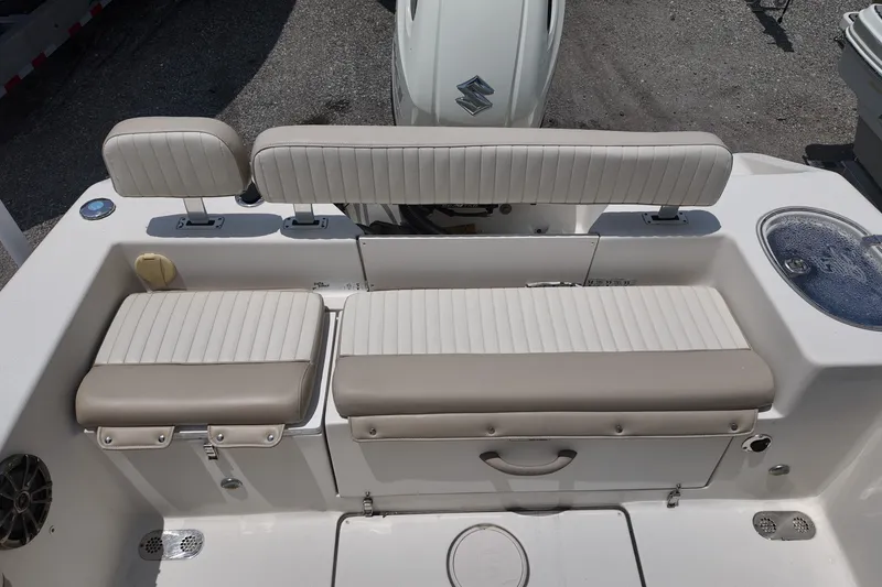 Slide: The Image of 2018 Sea Chaser 22 HFC boat interior with cushioned seating and storage compartments. - 11