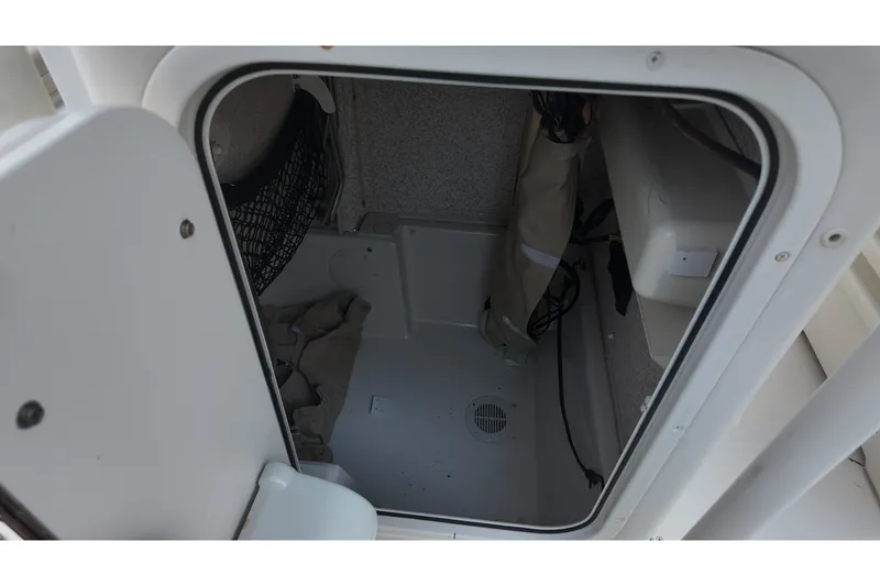 Slide: The Image of 2018 Sea Chaser 22 HFC storage compartment with netting and wiring. - 16