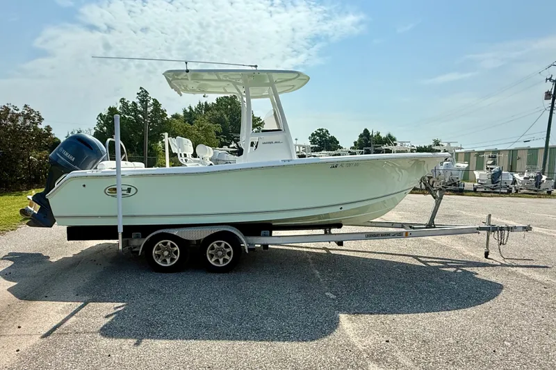 Slide: The Image of 2016 Sea Hunt Ultra 211 boat on trailer, parked outdoors under a clear sky. - 5