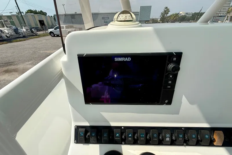 Slide: The Image of Control panel of a 2016 Sea Hunt Ultra 211 boat with Simrad display. - 14