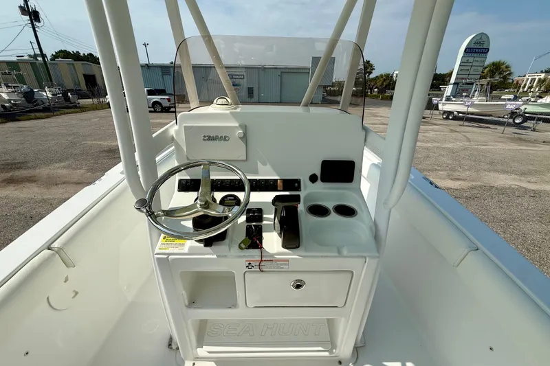 Slide: The Image of 2016 Sea Hunt Ultra 211 boat console with steering wheel and controls. - 7