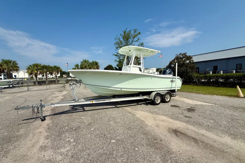 The Image of 2016 Sea Hunt Ultra 211 boat on trailer in sunny outdoor setting. - 0