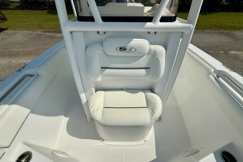 Slide: The Image of 2016 Sea Hunt Ultra 211 boat interior with white seating and console. - 11
