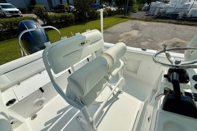 Slide: The Image of 2016 Sea Hunt Ultra 211 boat interior with white seating and steering wheel. - 8