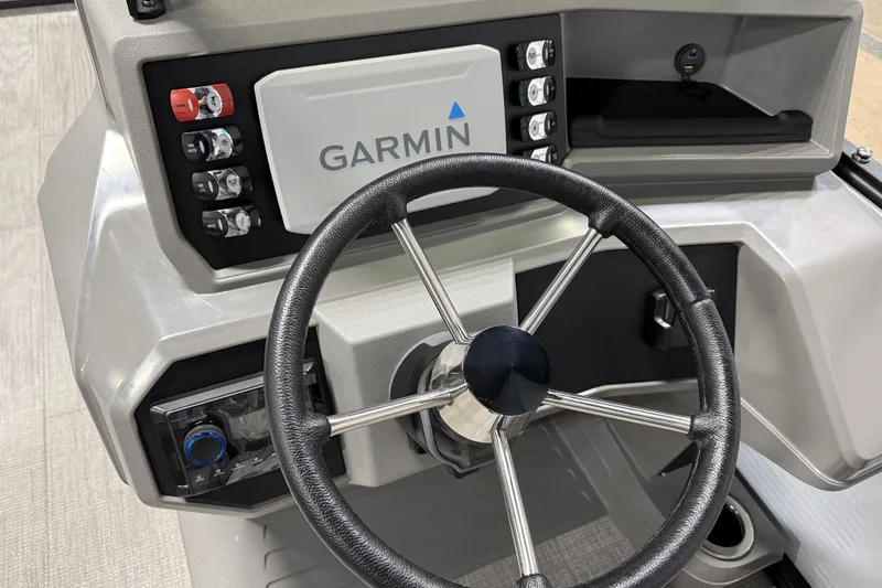 Slide: The Image of Steering console of 2025 Qwest 8518 LANAI LT with Garmin navigation system. - 1