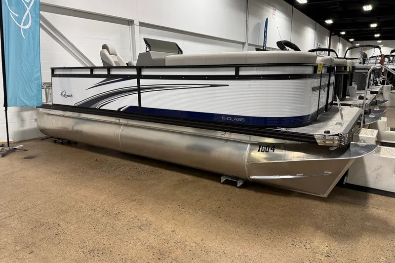 The Image of 2025 Qwest 8518 LANAI LT pontoon boat displayed indoors, showcasing sleek design and modern features. - 0