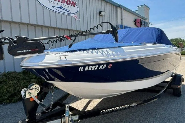 Slide: The Image of 2012 Chaparral 19 H2O Ski & Fish boat on trailer, blue cover, parked outside. - 26