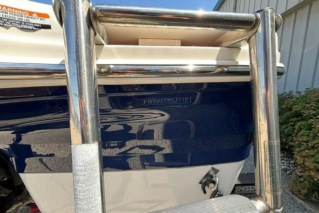Slide: The Image of 2012 Chaparral 19 H2O Ski & Fish boat with stainless steel ladder and blue hull. - 27