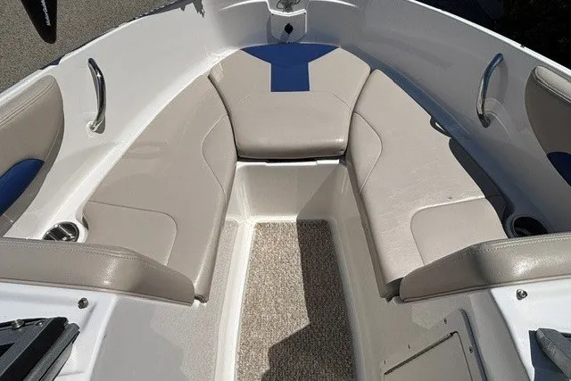Slide: The Image of 2012 Chaparral 19 H2O Ski & Fish boat interior with cushioned seating and carpeted floor. - 18