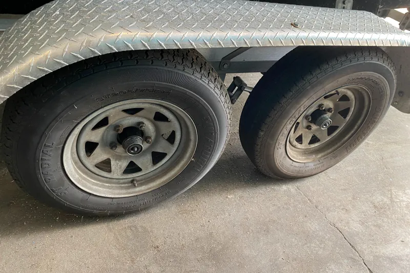 Slide: The Image of Close-up of a boat trailer with two tires on a concrete floor. - 21