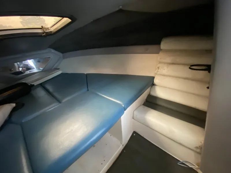Slide: The Image of Interior of a 1990 MasterCraft Maristar 240 with blue and white upholstery. - 16