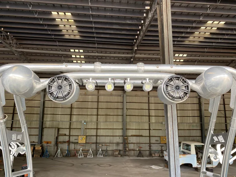 Slide: The Image of A boat tower with speakers and lights inside a warehouse. - 22