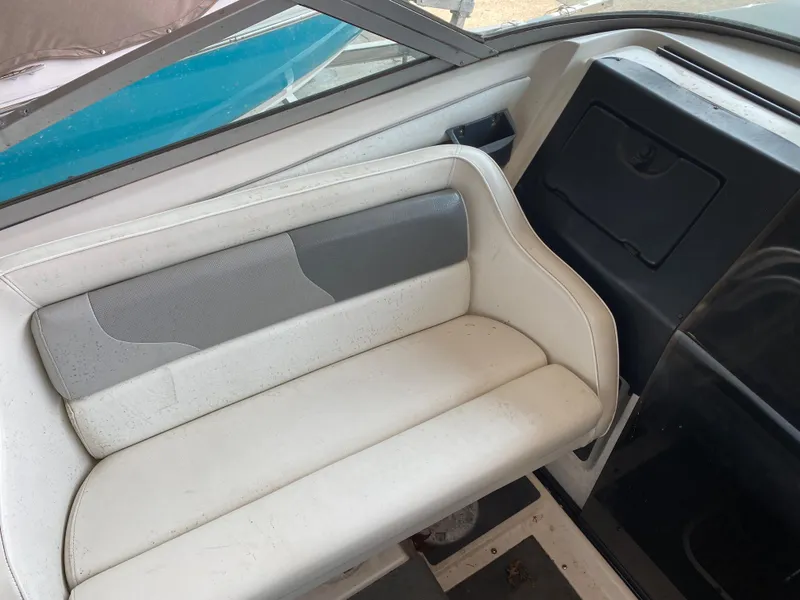 Slide: The Image of Interior of a 1990 MasterCraft Maristar 240 with white seating and gray accents. - 13