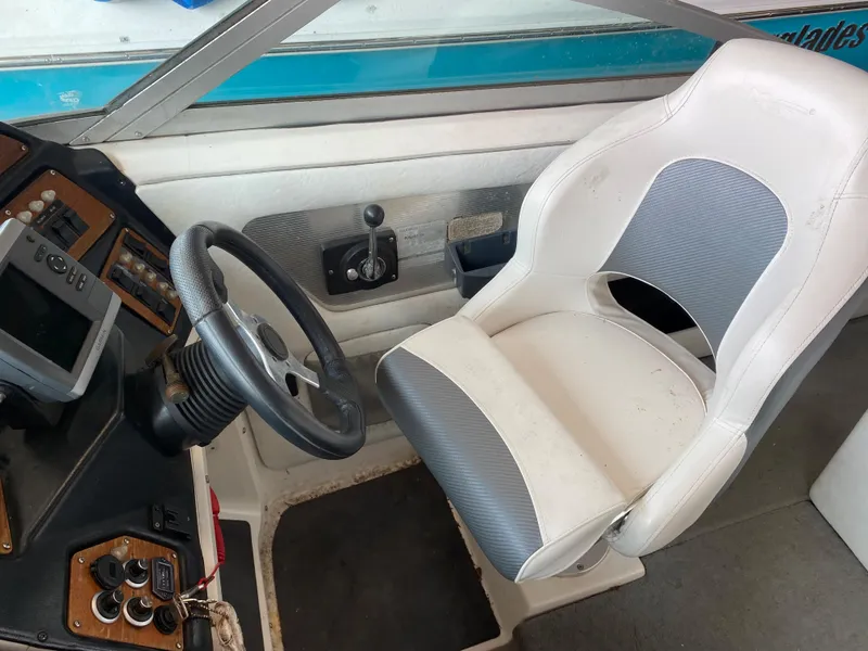 Slide: The Image of The image shows the helm of a 1990 MasterCraft Maristar 240 with a white seat. - 11