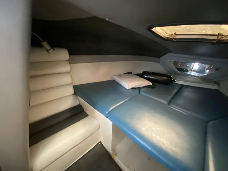 Slide: The Image of Interior of a 1990 MasterCraft Maristar 240 with blue and white upholstery. - 15