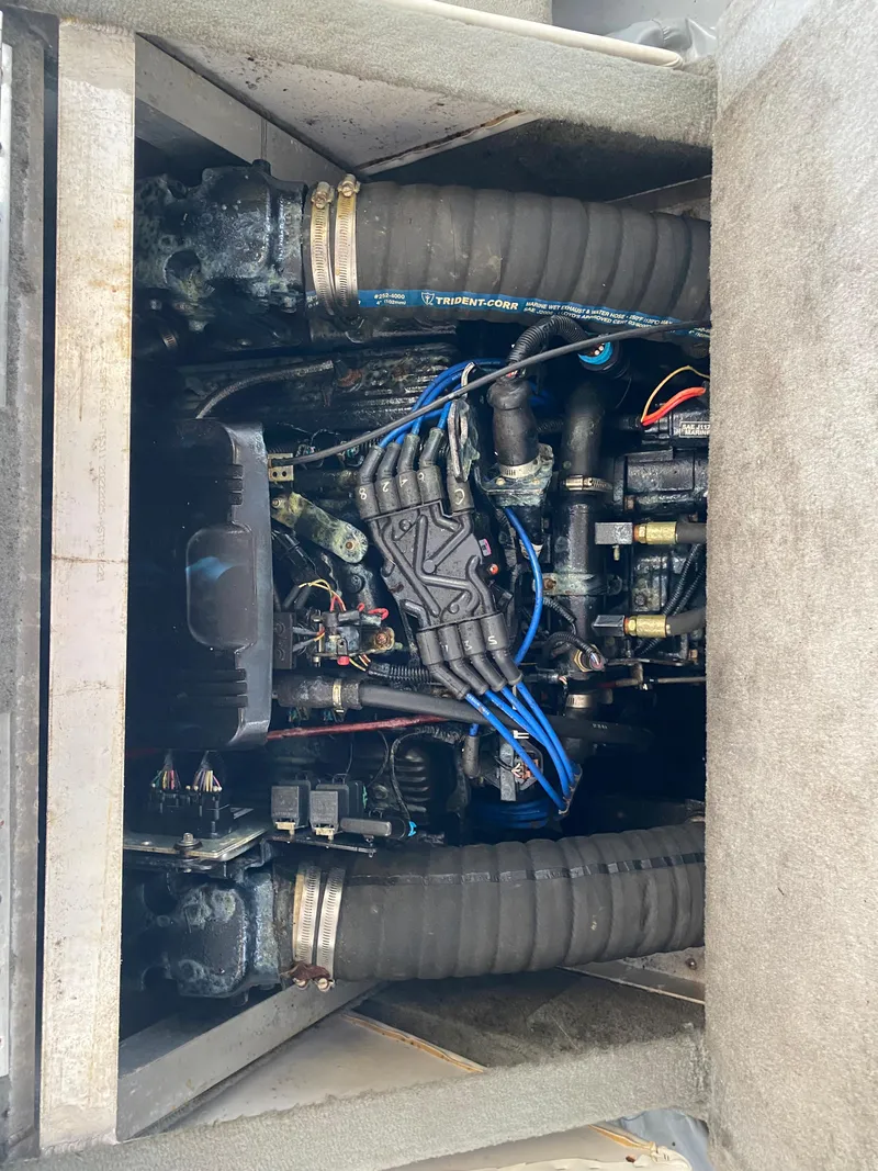 Slide: The Image of A boat engine compartment with visible hoses and wiring. - 18