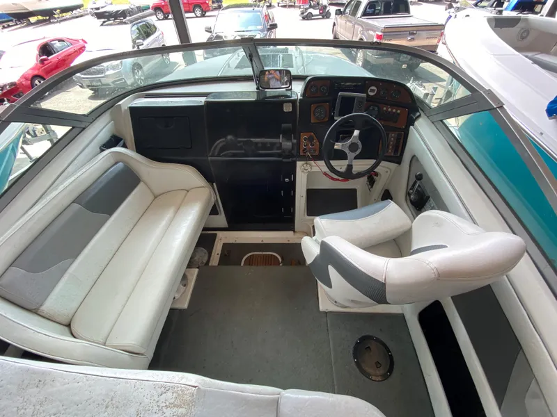 Slide: The Image of Interior view of a 1990 MasterCraft Maristar 240 with white seating and a helm station. - 10