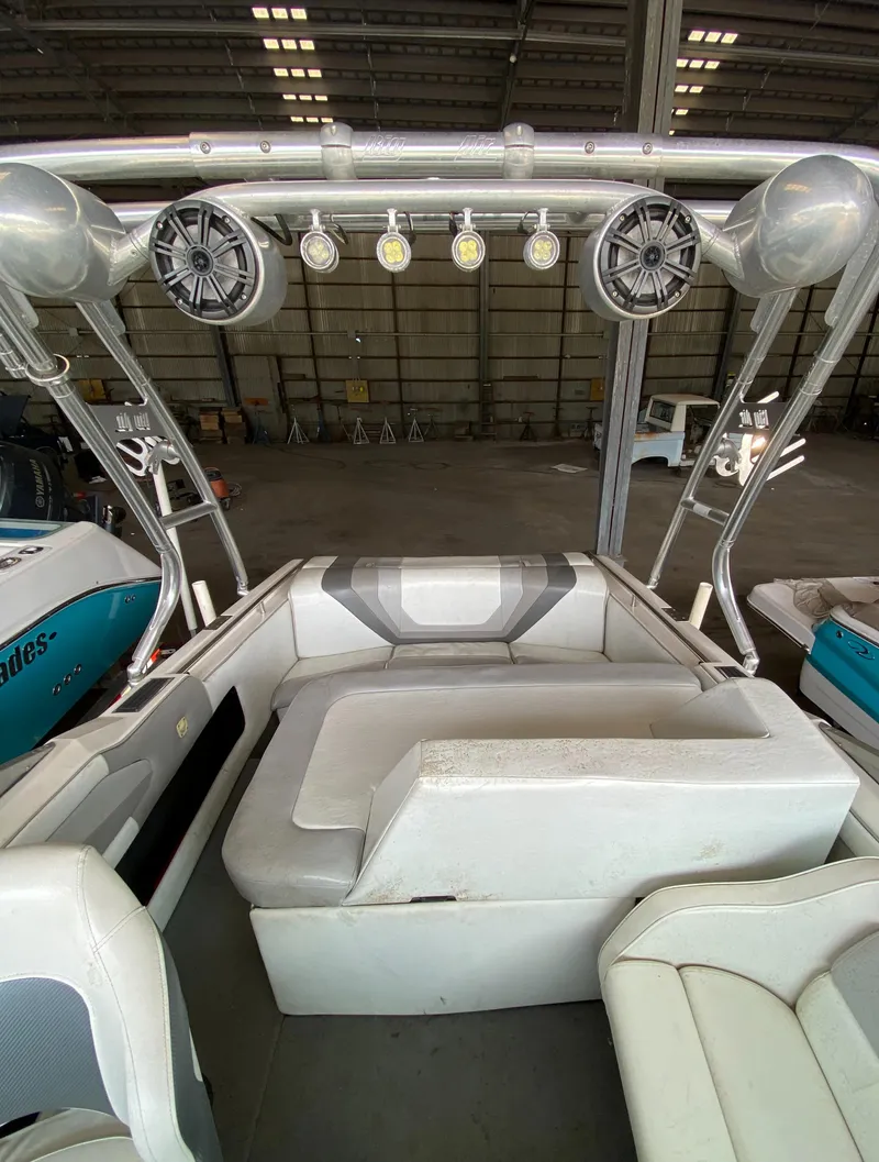 Slide: The Image of The image shows the interior of a 1990 MasterCraft Maristar 240 with white seating and speakers. - 20