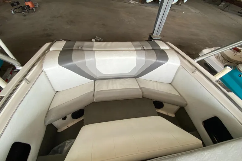 Slide: The Image of The image shows the seating area of a 1990 MasterCraft Maristar 240 with cushioned seats. - 8
