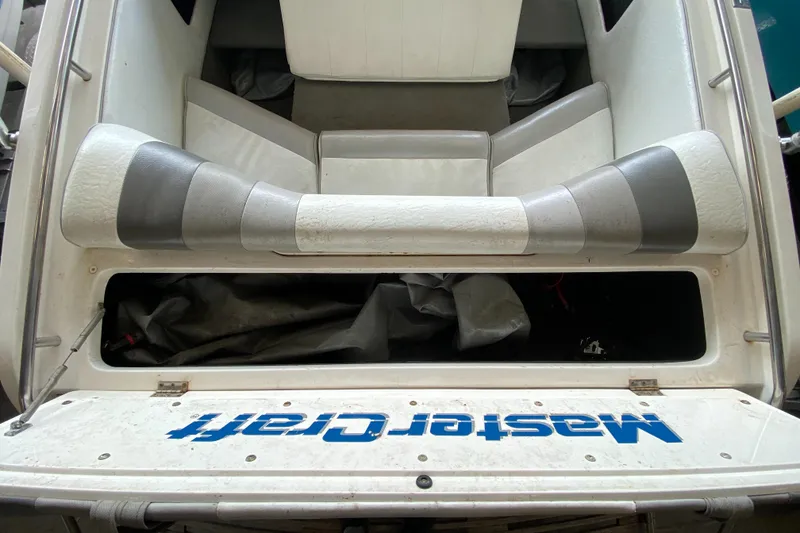 Slide: The Image of Rear view of a 1990 MasterCraft Maristar 240 with gray and white upholstery. - 7