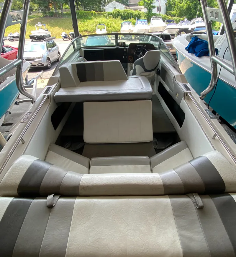 Slide: The Image of The image shows the interior of a 1990 MasterCraft Maristar 240 with striped seating. - 6