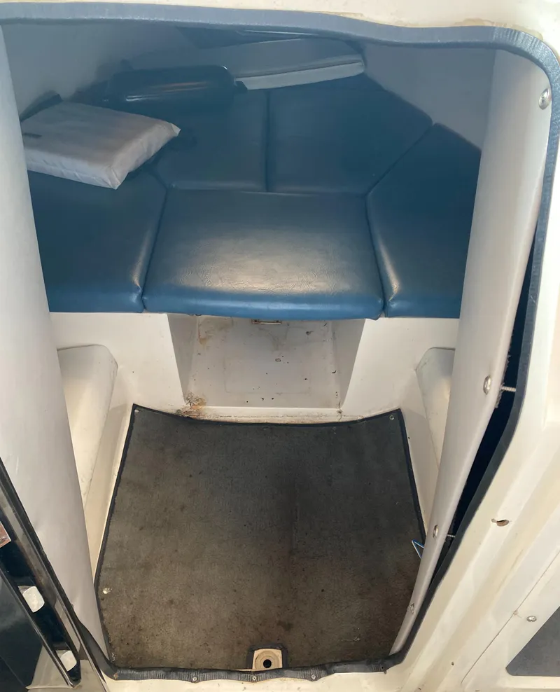 Slide: The Image of The image shows the interior of a 1990 MasterCraft Maristar 240 with blue upholstery. - 14