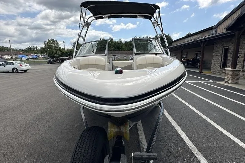 Slide: The Image of 2008 Tahoe Q6 Sport boat on trailer, parked outdoors under cloudy sky. - 8