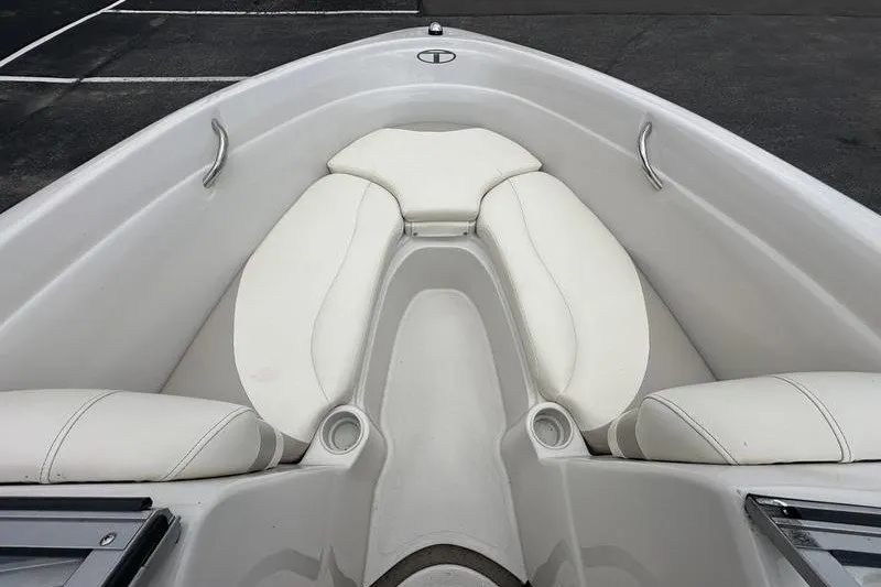 Slide: The Image of Interior view of a 2008 Tahoe Q6 Sport boat with white cushioned seating. - 20