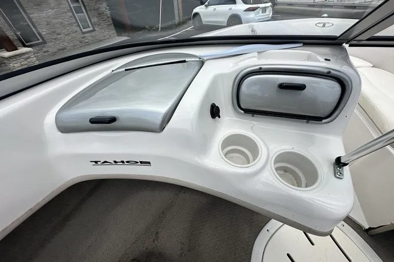 Slide: The Image of Interior of a 2008 Tahoe Q6 Sport boat with cup holders and storage compartments. - 23